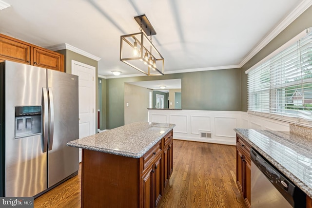 5 Brookfield Rd, Pasadena, MD 21122 - kitchen featuring stainless steel appliances, brown cabinetry, dark wood-style flooring, crown molding, and light stone countertops