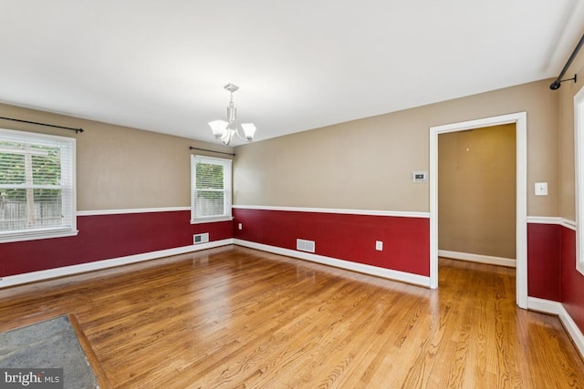 5 Brookfield Rd, Pasadena, MD 21122 - spare room with a chandelier, plenty of natural light, and wood finished floors