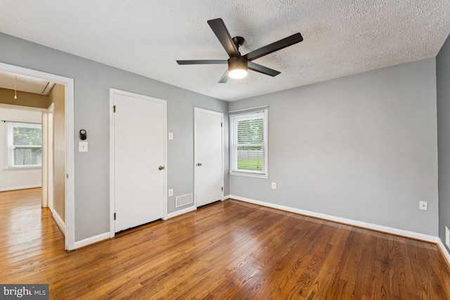 5 Brookfield Rd, Pasadena, MD 21122 - unfurnished bedroom featuring attic access, wood finished floors, a textured ceiling, and ceiling fan
