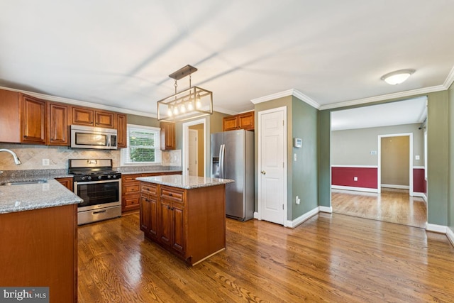 5 Brookfield Rd, Pasadena, MD 21122 - kitchen with stainless steel appliances, ornamental molding, dark wood-style flooring, and brown cabinets