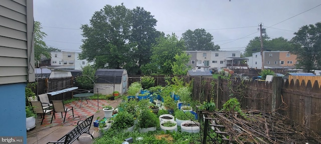 867 Wedgewood Dr, Lansdale, PA 19446 - fenced backyard featuring a patio, a residential view, a vegetable garden, and a storage shed