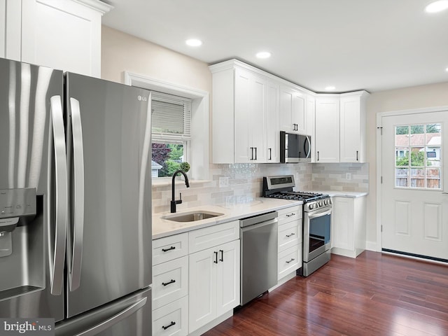 105 Bette Rd, Wilmington, DE 19803 - kitchen featuring appliances with stainless steel finishes, healthy amount of natural light, decorative backsplash, dark wood-style floors, and recessed lighting