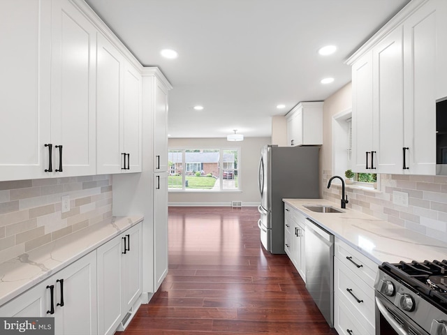 105 Bette Rd, Wilmington, DE 19803 - kitchen featuring appliances with stainless steel finishes, dark wood-style floors, white cabinets, backsplash, and recessed lighting