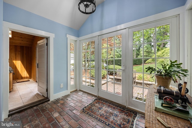 136 Lambs Rd, Sewell, NJ 08080 - entryway with plenty of natural light, lofted ceiling, wooden walls, and brick floors