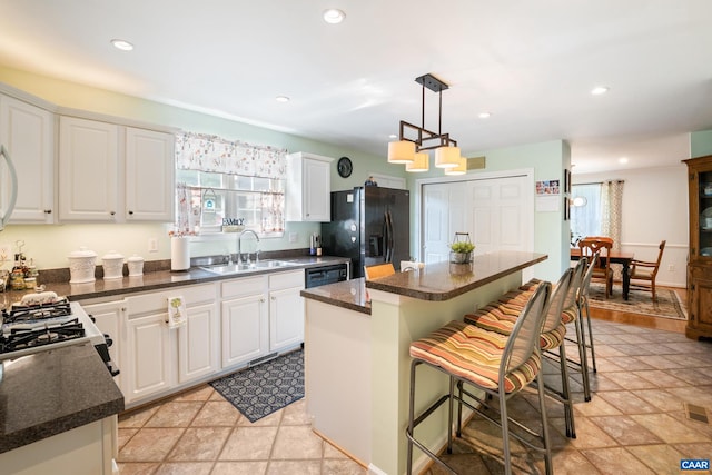 1500 Honeysuckle Ln, Charlottesville, VA 22902 - kitchen featuring black refrigerator with ice dispenser, a kitchen island, white cabinets, a kitchen bar, and recessed lighting