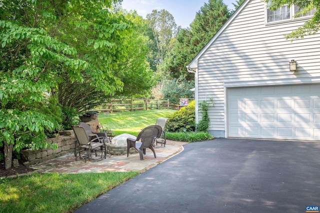 1500 Honeysuckle Ln, Charlottesville, VA 22902 - view of yard featuring asphalt driveway, a garage, and an outdoor fire pit