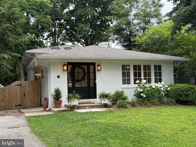 8 Lawrence Ave, Annapolis, MD 21403 - view of front of house featuring brick siding, a front yard, a chimney, roof with shingles, and a gate
