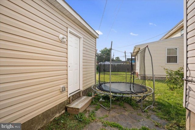 8255 Longpoint Rd, Baltimore, MD 21222 - view of yard with a trampoline and entry steps