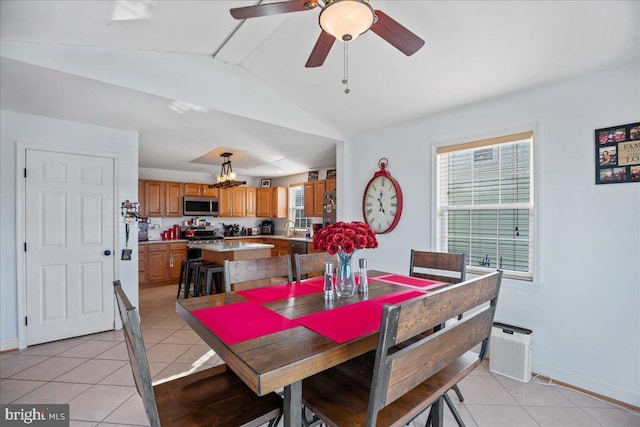 8255 Longpoint Rd, Baltimore, MD 21222 - dining area featuring light tile patterned floors, vaulted ceiling, ceiling fan, and a chandelier