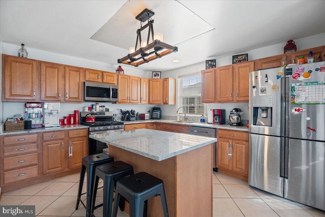8255 Longpoint Rd, Baltimore, MD 21222 - kitchen with appliances with stainless steel finishes, light tile patterned floors, light stone countertops, a kitchen island, and a breakfast bar