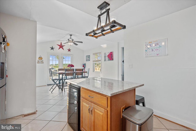 8255 Longpoint Rd, Baltimore, MD 21222 - kitchen featuring wine cooler, light tile patterned floors, vaulted ceiling, ceiling fan, and light stone countertops