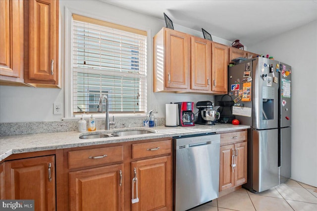 8255 Longpoint Rd, Baltimore, MD 21222 - kitchen featuring stainless steel appliances, light tile patterned floors, light stone countertops, and brown cabinets