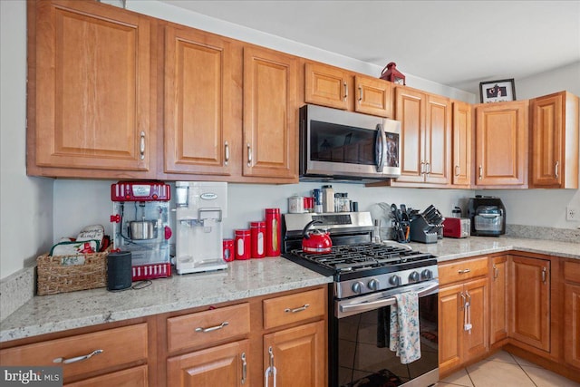 8255 Longpoint Rd, Baltimore, MD 21222 - kitchen featuring stainless steel appliances, light stone countertops, and brown cabinets