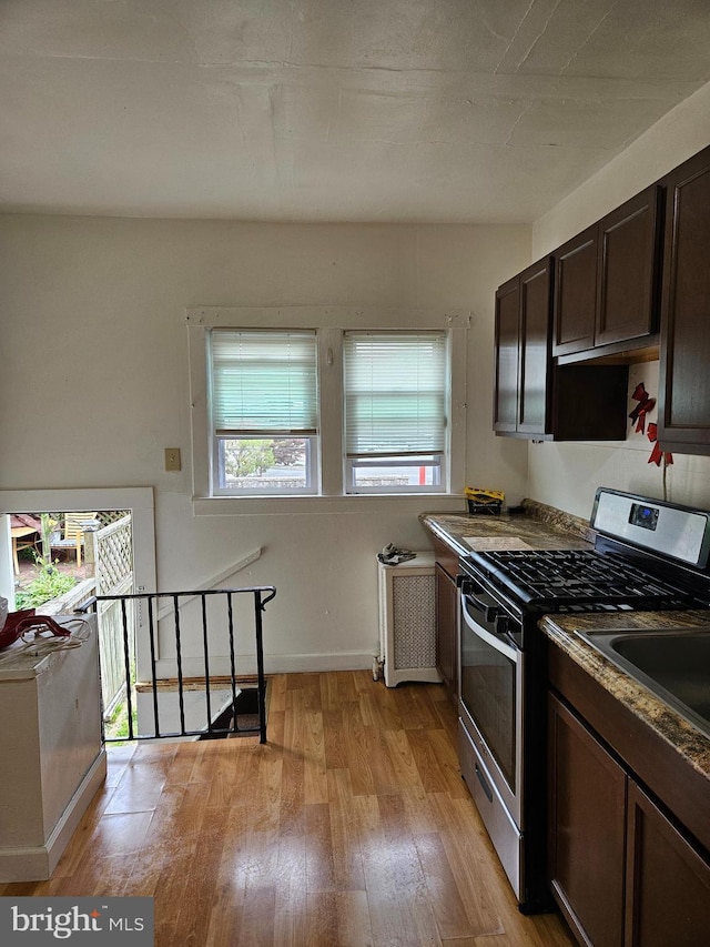 48 Bellevue Ter, Collingswood, NJ 08108 - kitchen featuring gas stove, light wood-type flooring, and dark brown cabinetry