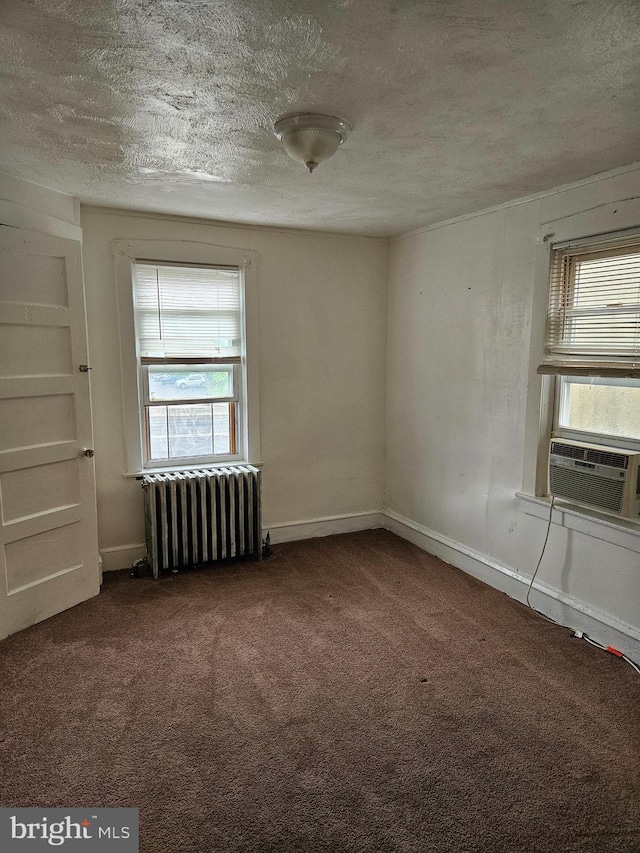 48 Bellevue Ter, Collingswood, NJ 08108 - carpeted empty room featuring radiator heating unit, a textured ceiling, cooling unit, and plenty of natural light
