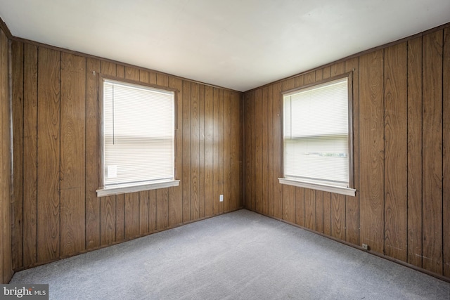 2301 Airacobra St, Levittown, PA 19057 - carpeted empty room with plenty of natural light and wood walls