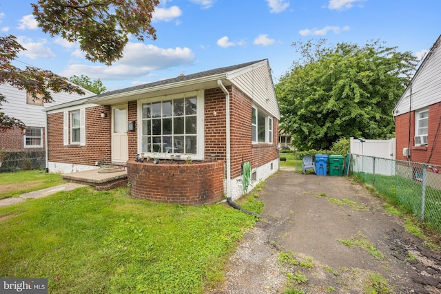 2301 Airacobra St, Levittown, PA 19057 - view of front of property featuring brick siding, cooling unit, and driveway