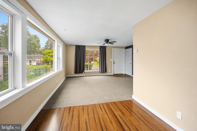 2301 Airacobra St, Levittown, PA 19057 - empty room featuring healthy amount of natural light, wood finished floors, and ceiling fan