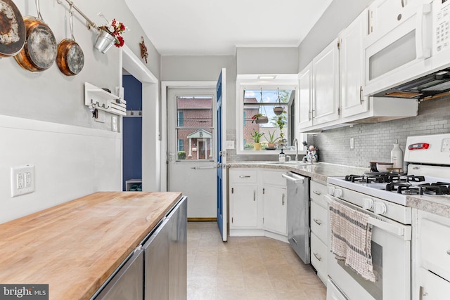 101 Ash Rd, Wallingford, PA 19086 - kitchen with white appliances, tasteful backsplash, white cabinets, and wood counters