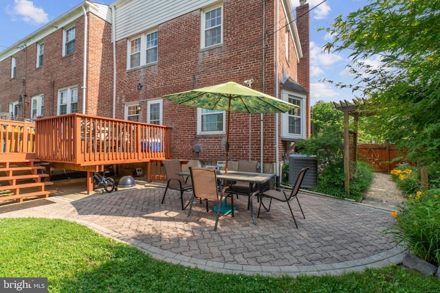 1931 Edgewood Rd, Towson, MD 21286 - rear view of house featuring a wooden deck, a pergola, brick siding, and a patio