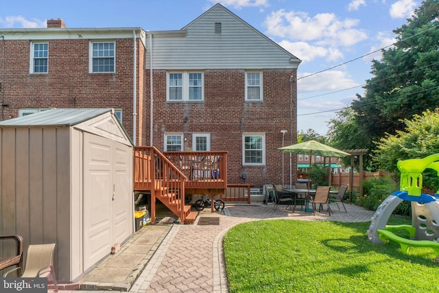 1931 Edgewood Rd, Towson, MD 21286 - rear view of house featuring a patio area, brick siding, a shed, and a wooden deck