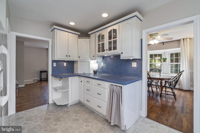 1931 Edgewood Rd, Towson, MD 21286 - kitchen featuring dark countertops, decorative backsplash, open shelves, glass insert cabinets, and a ceiling fan