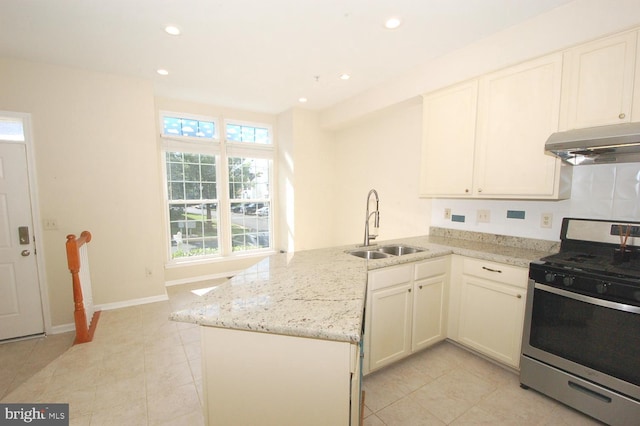 12013 Panthers Ridge Dr, Germantown, MD 20876 - kitchen featuring gas range, under cabinet range hood, a peninsula, light stone counters, and recessed lighting