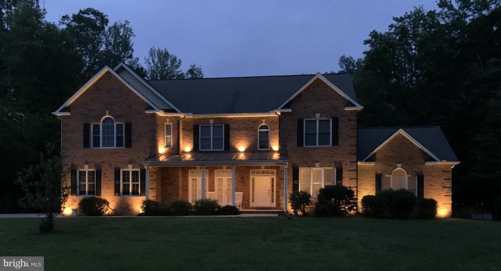 182 Wood Landing Rd, Fredericksburg, VA 22405 - view of front facade with brick siding, a front lawn, and covered porch
