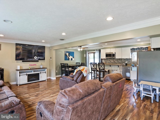 15 Nightingale St, Keyser, WV 26726 - living area featuring dark wood-style floors, ornamental molding, a ceiling fan, and recessed lighting