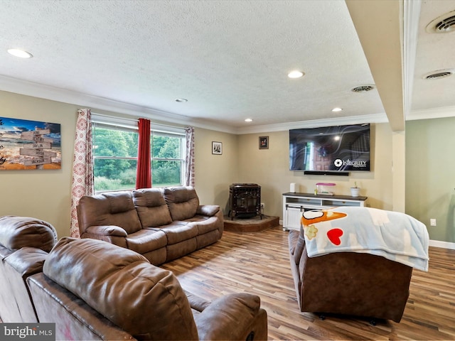 15 Nightingale St, Keyser, WV 26726 - living area with a wood stove, crown molding, wood finished floors, recessed lighting, and a textured ceiling