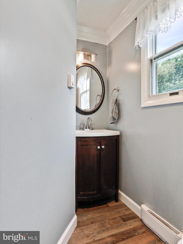 15 Nightingale St, Keyser, WV 26726 - bathroom featuring a baseboard heating unit, ornamental molding, vanity, and wood finished floors