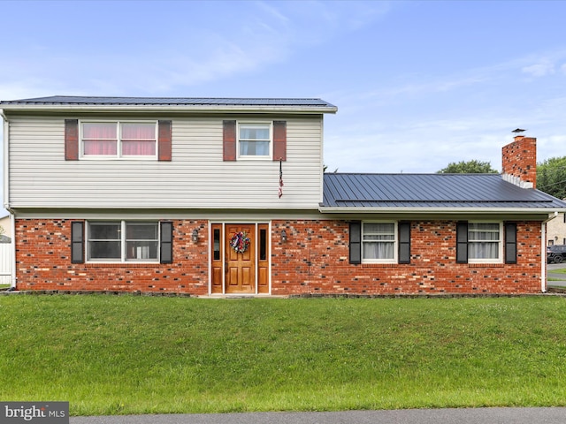 15 Nightingale St, Keyser, WV 26726 - view of front of home with a front yard, brick siding, a chimney, and a metal roof
