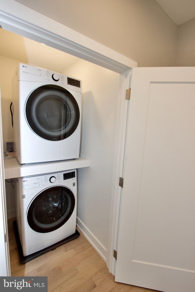 2417 N Hancock St, Philadelphia, PA 19133 - laundry area with stacked washer / dryer and light wood-style flooring