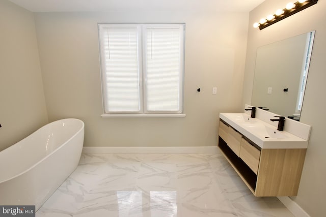 2417 N Hancock St, Philadelphia, PA 19133 - full bath with marble look tile flooring, double vanity, and a freestanding bath
