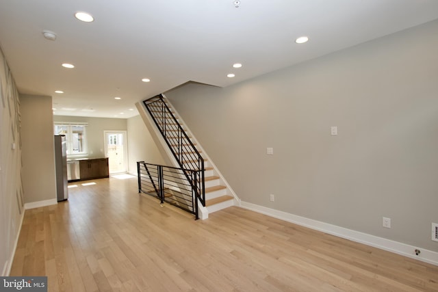 2417 N Hancock St, Philadelphia, PA 19133 - unfurnished living room with light wood finished floors, stairs, and recessed lighting