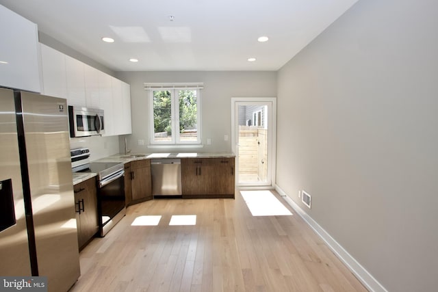 2417 N Hancock St, Philadelphia, PA 19133 - kitchen featuring stainless steel appliances, white cabinetry, light wood-style flooring, modern cabinets, and recessed lighting