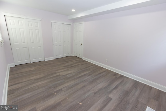 10040 Jeanes St, Philadelphia, PA 19116 - unfurnished bedroom featuring multiple closets, dark wood-type flooring, and recessed lighting