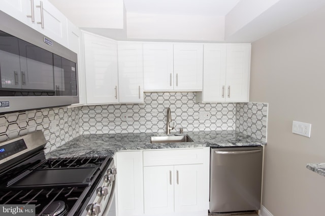 10040 Jeanes St, Philadelphia, PA 19116 - kitchen featuring appliances with stainless steel finishes, white cabinetry, decorative backsplash, and light stone counters