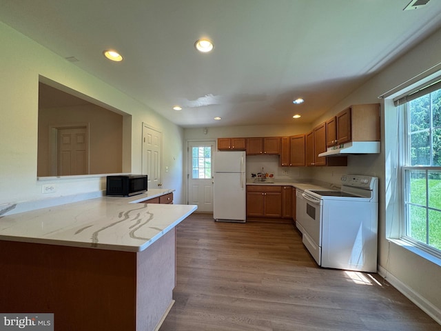 7904 Windsor Knoll Ln, Laytonsville, MD 20882 - kitchen featuring white appliances, plenty of natural light, recessed lighting, under cabinet range hood, and wood finished floors