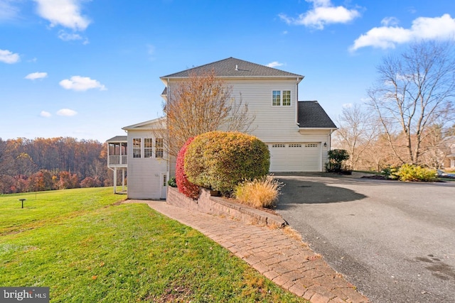 7904 Windsor Knoll Ln, Laytonsville, MD 20882 - view of home's exterior featuring asphalt driveway, a garage, a lawn, and a sunroom