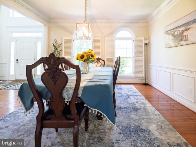 7904 Windsor Knoll Ln, Laytonsville, MD 20882 - dining space with crown molding, a wainscoted wall, a decorative wall, and wood finished floors