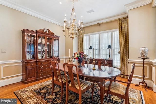 9858 Palace Green Way, Vienna, VA 22181 - dining room featuring a chandelier, wainscoting, light wood-style flooring, ornamental molding, and a decorative wall