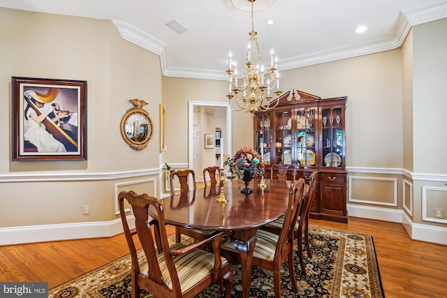 9858 Palace Green Way, Vienna, VA 22181 - dining area featuring a chandelier, wood finished floors, crown molding, wainscoting, and recessed lighting