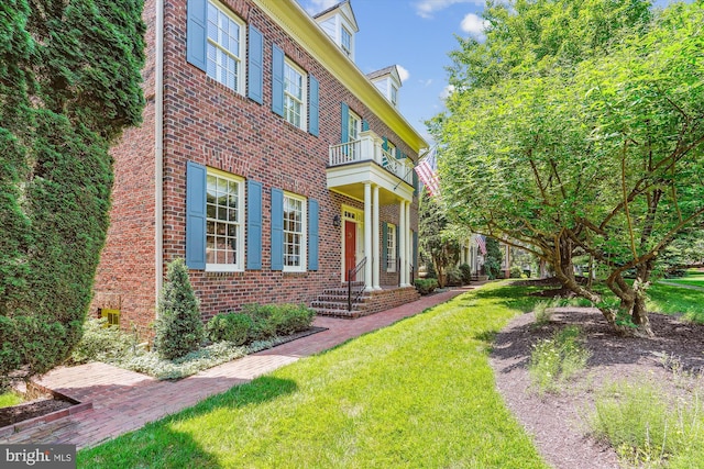 9858 Palace Green Way, Vienna, VA 22181 - view of front of home with a balcony, brick siding, and a front lawn