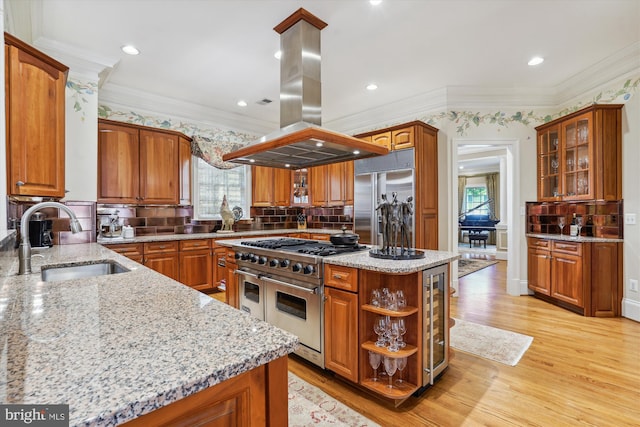 9858 Palace Green Way, Vienna, VA 22181 - kitchen featuring high quality appliances, island exhaust hood, plenty of natural light, brown cabinetry, and ornamental molding