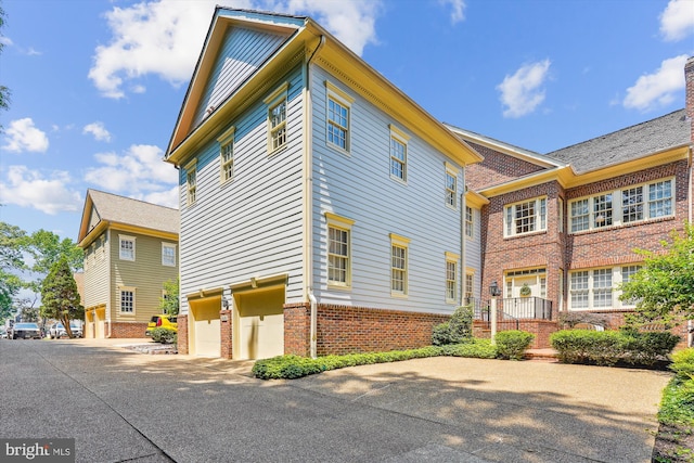 9858 Palace Green Way, Vienna, VA 22181 - view of home's exterior with brick siding, a garage, and driveway