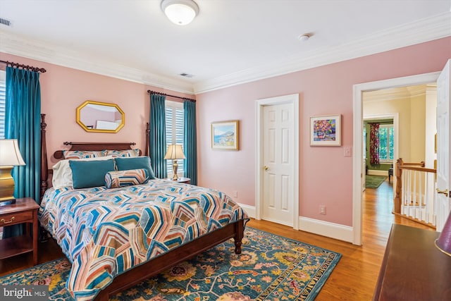 9858 Palace Green Way, Vienna, VA 22181 - bedroom with light wood finished floors and crown molding