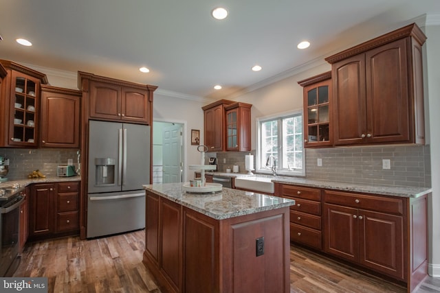 26294 Evesboro Ln, Eden, MD 21822 - kitchen featuring stainless steel appliances, crown molding, dark wood finished floors, a kitchen island, and backsplash
