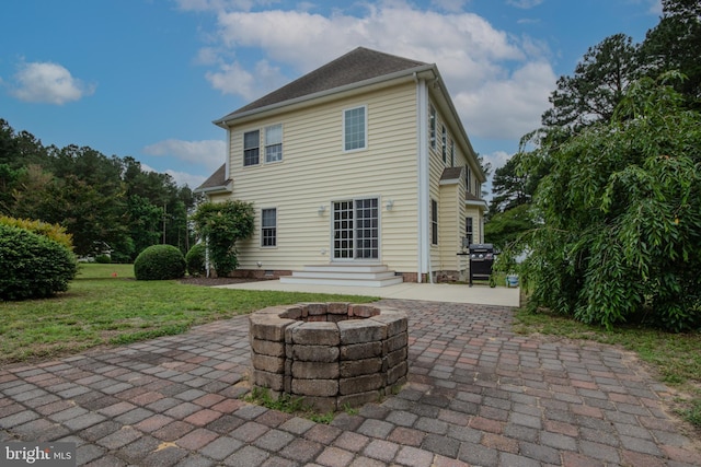 26294 Evesboro Ln, Eden, MD 21822 - rear view of house featuring a patio area, a fire pit, a lawn, and entry steps