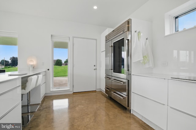 317 Clearview Ave, Nazareth, PA 18064 - kitchen featuring high quality fridge, concrete flooring, white cabinets, light countertops, and recessed lighting
